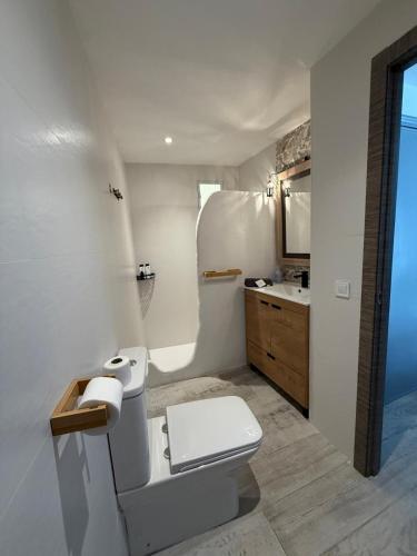 a white bathroom with a toilet and a sink at Villa Atlantic Marquesa - Punta Umbria in Punta Umbría