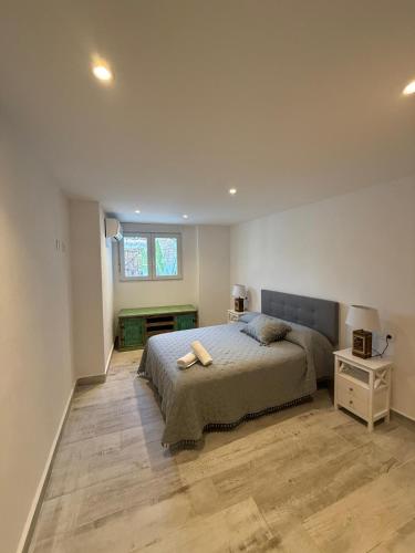a bedroom with a bed and a desk and a window at Villa Atlantic Marquesa - Punta Umbria in Punta Umbría