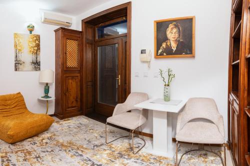 a living room with a table and two chairs at Baroque Residence in Timişoara