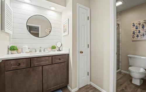 a bathroom with a sink and a toilet and a mirror at 359 Tarpon Blvd in Fripp Island