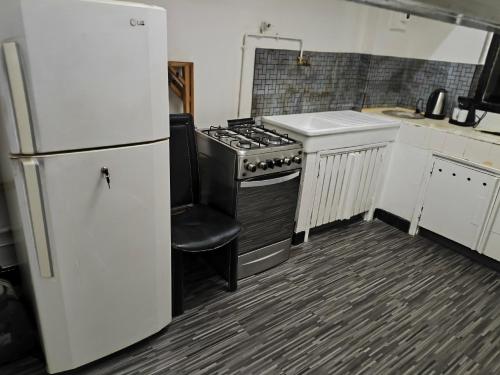 a kitchen with a stove and a refrigerator at Studio chambre salon cuisine in Dakar