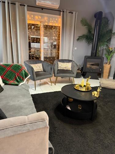 a living room with a couch and a coffee table at RHODESIA guest house in Chalkida