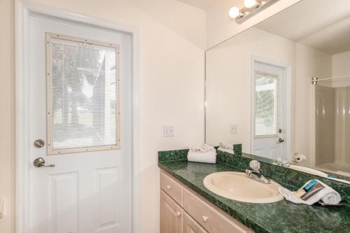 a bathroom with a sink and a mirror at Van Ness Poolhome - Lake access 2mi in Hernando