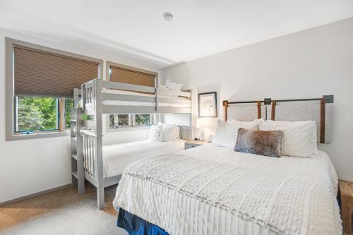 a bedroom with two bunk beds and a window at Tamarak 36 in Snowmass Village