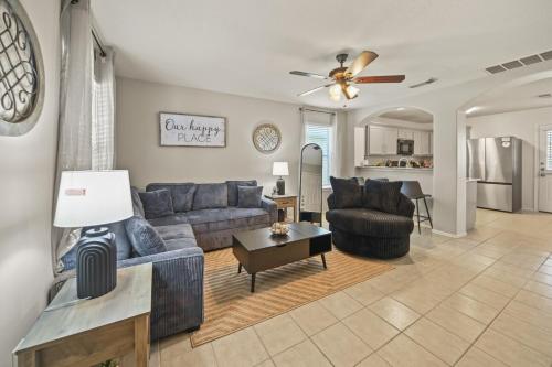 a living room with a couch and a table at Our Happy Place in Humble