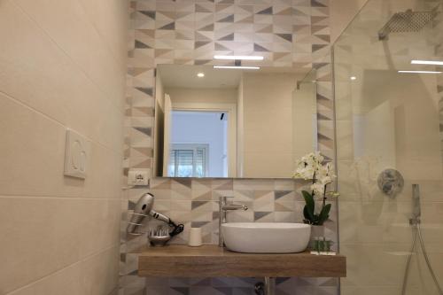 a bathroom with a sink and a mirror at SUNSEA - Enjoy Your Family in Capo Vaticano
