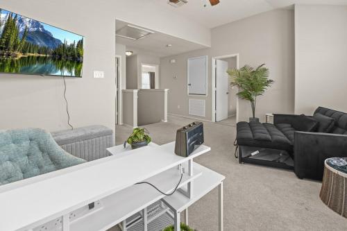 a living room with a couch and a tv at Our Happy Place in Humble