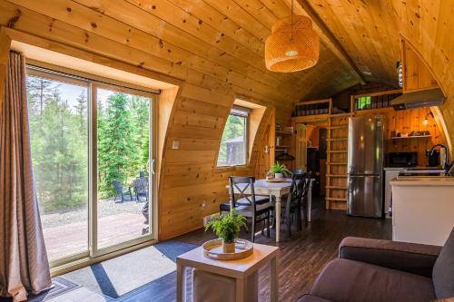 een woonkamer en keuken van een klein huis bij POD'Stress Nature et Tranquilité in Saint-Alexis-des-Monts
