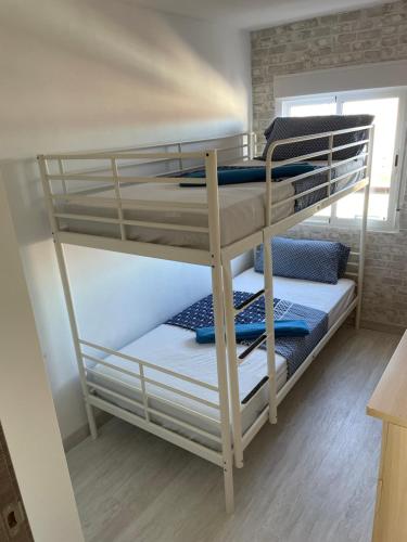 a couple of bunk beds in a room at Piso trabajo Rocafort 2 in Madrid