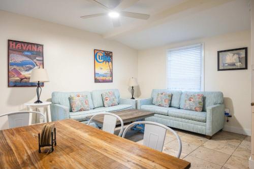 a living room with two blue couches and a table at Sea Breeze -Great Location! in Key West