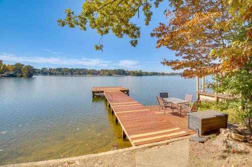 a dock on a lake with a table and chairs at 10 Mi to National Park Patio at Hot Springs Home in Hot Springs