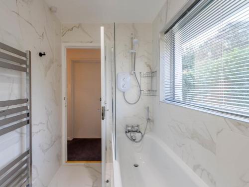 a white bathroom with a tub and a shower at 2 Bed in Wareham oc-79228 in West Lulworth