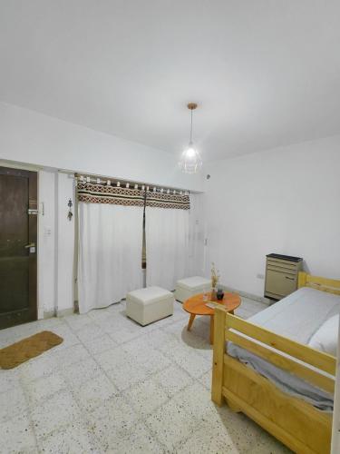 a bedroom with a bed and a table at Nami in Necochea