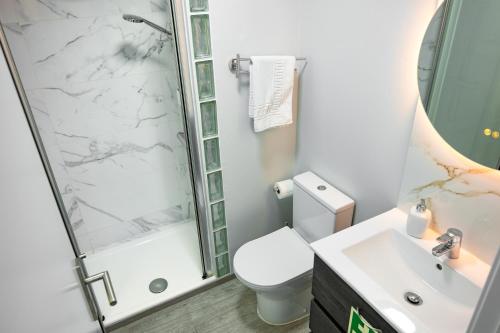 a bathroom with a shower and a toilet and a sink at LaurissilvaLodge in Senhora do Rosário