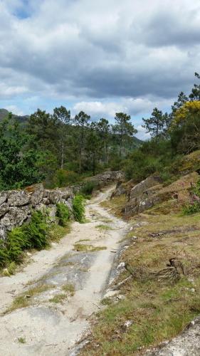 a dirt road on the side of a mountain at Casa da Gandarela in Soajo