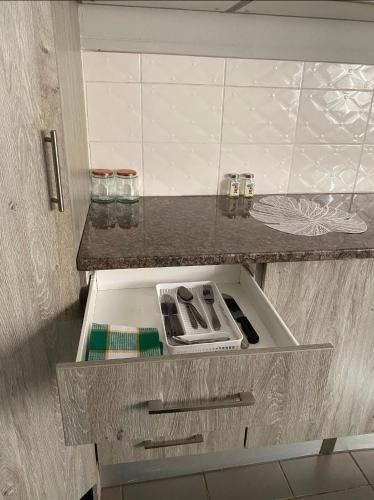 an open drawer in a kitchen with a stove at Vaal Home near Aquadome in Vanderbijlpark