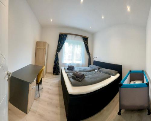 a bedroom with a bed and a desk in it at Trojaner in Oberort