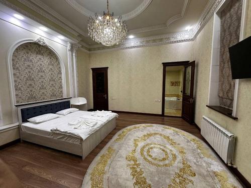 a bedroom with a bed and a large rug at Cosmos Hotel in Yakkasaray