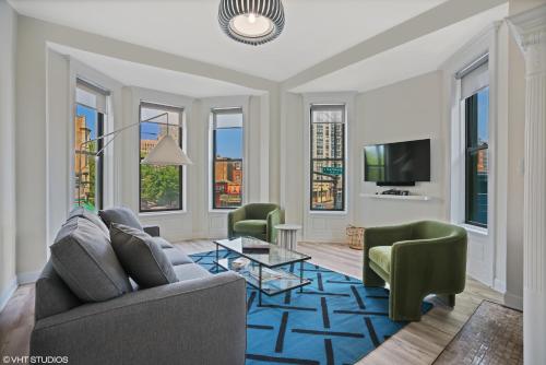 a living room with a couch and chairs and a tv at The Neighborhood Hotel - Lincoln Park 501 - Three Bedroom Penthouse in Chicago