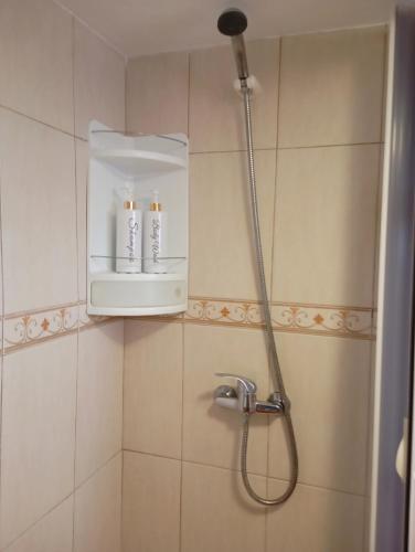 a bathroom with a shower with two candles in it at Adega Velha in Calheta de Nesquim