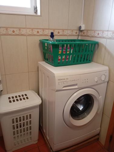 a washing machine with a basket on top of it at Adega Velha in Calheta de Nesquim