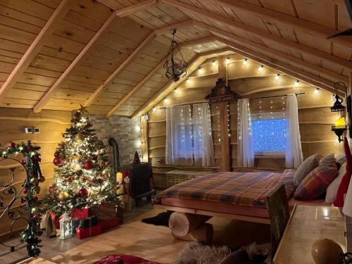 a bedroom with a christmas tree in a room at Zonamita house in Velika Remeta