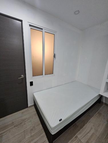 Giường trong phòng chung tại Hospedaje La Escondida