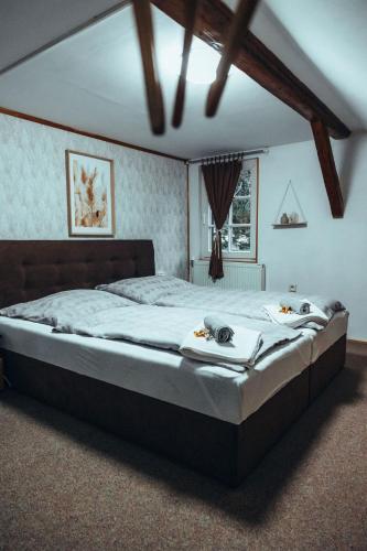 a bedroom with a large bed with two towels on it at Chalupa Laura in Bublava