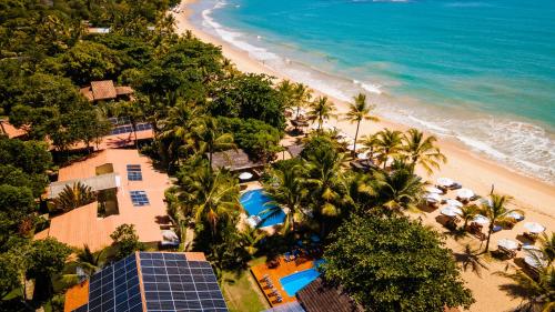 an aerial view of a beach with palm trees at Travel Inn Pousadas & Beach Club Trancoso in Trancoso