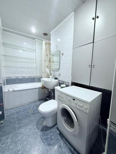 a bathroom with a washing machine and a toilet at 2 Bedroom 2 bathroom Republic Square in Yerevan