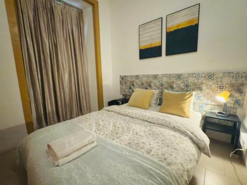 a bedroom with a bed and a lamp on a table at Frank's House & Happy BELEM in Lisbon