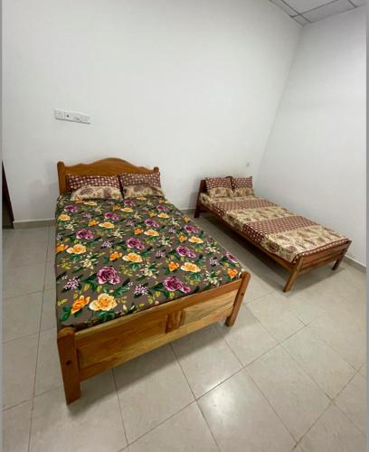 a bedroom with two beds and a couch in it at Moringa Villa in Maruthanamadam