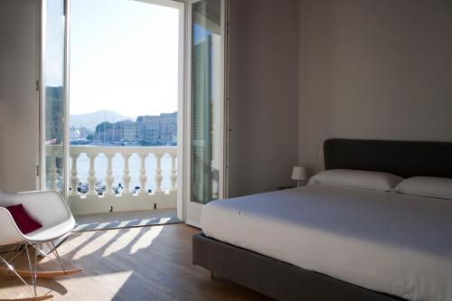 a bedroom with a bed and a view of a balcony at Porto Sole Rooms in Portoferraio