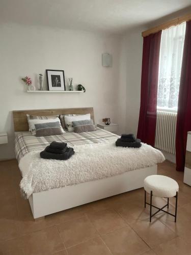a bedroom with a large bed and a chair at Alpine's Apartment in Arnoldstein