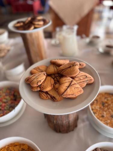 a plate of cookies on a table with other bowls of food at Hotel Horacio Quiroga in Termas de Salto Grande