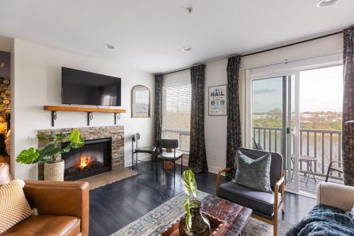 a living room with a fireplace and a balcony at Condo in the Heart of Nashville - unit794 in Nashville