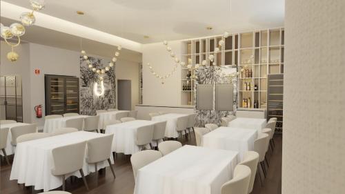 ein Esszimmer mit weißen Tischen und weißen Stühlen in der Unterkunft Casa Correio Boutique Hotel in Valença