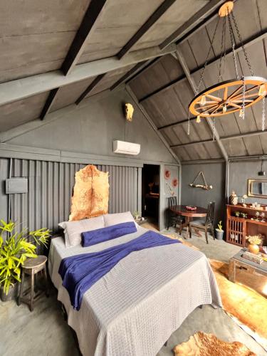 a bedroom with a large bed and a table at Cabana Pegasus in Ibicoara