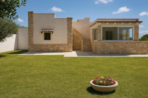 a house with a vase of flowers in a yard at AlliPatuli Apartments in Gallipoli