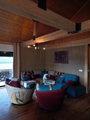 a living room with couches and chairs in a room at Chalet EGAT in Égat