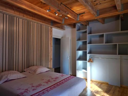 a bedroom with a bed and a book shelf at Chalet EGAT in Égat