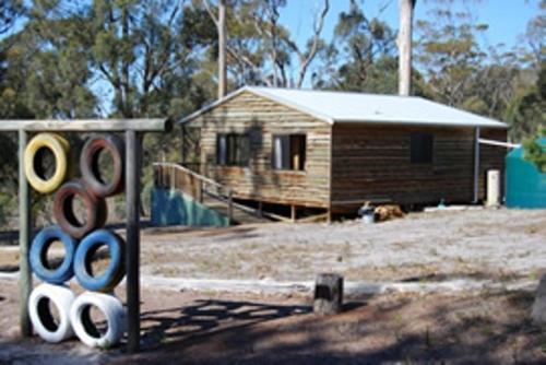 a house with a group of olympic rings in front of it at Gumleaves Bush Holidays in Little Swanport