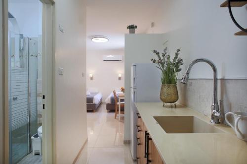 a kitchen with a sink and a refrigerator at Melony Tsfat in Safed
