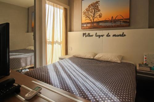 Ein Schlafzimmer mit einem Bett und einem Schild, auf dem steht: „Was auch immer jemals Minute in der Unterkunft Flat com Piscina, Academia e Sauna em Aguas Claras in Águas Claras