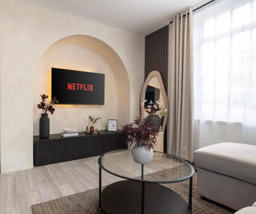 a living room with a table and a mirror at New Modern 2 Bedroom Central Apt Greater Manchester, Sleeps 5, Near Airport with Great Transport Links in Stockport