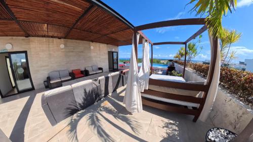 an outdoor patio with a view of the ocean at Grand Fifty Suites in Playa del Carmen