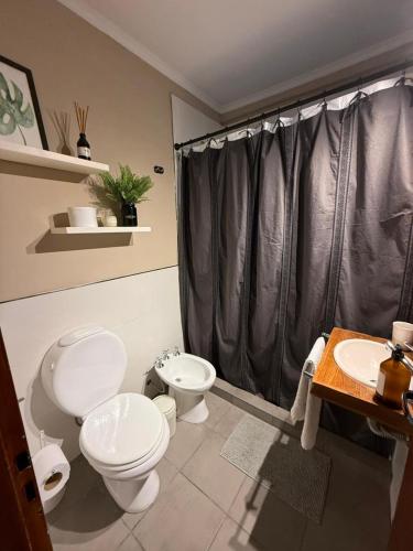 a bathroom with two toilets and a shower at Capibara 7 - Alborada in Corrientes
