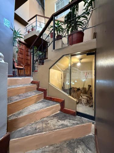 a staircase in a building with potted plants at La Casona de Palacio Viejo in Arequipa
