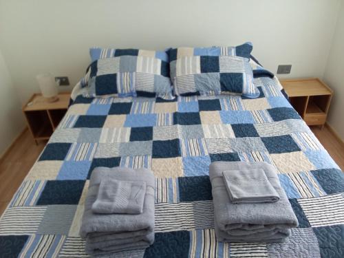 a bedroom with a bed with towels on it at Cozy cabin for 4 people San Pedro de Atacama in San Pedro de Atacama