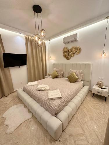 a bedroom with a large bed with a white bed frame at Villa Dar Soka in Marrakesh